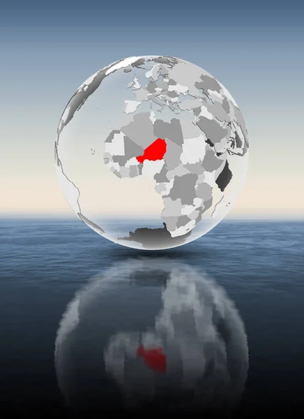 Niger in red on translucent globe floating above water. 3D illustration.