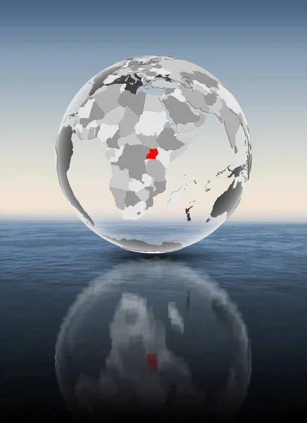 乌干达在红色在透明地球漂浮在水之上 — 图库照片