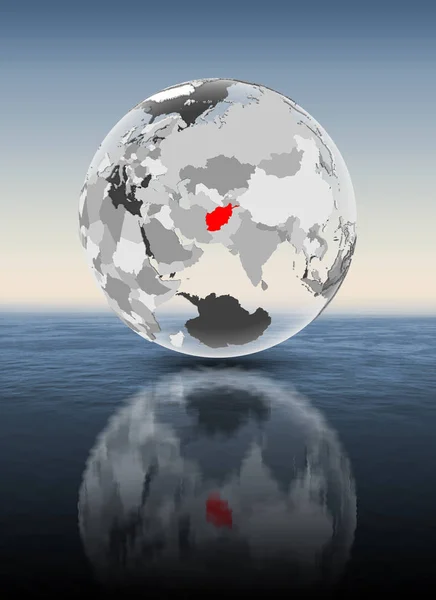 阿富汗在红色在透明地球漂浮在水之上 — 图库照片