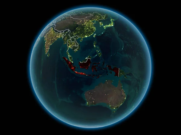 Indonesia in red with visible country borders and city lights from space at night. 3D illustration. Elements of this image furnished by NASA.