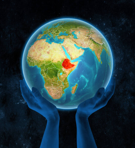 Ethiopia on planet Earth with visible country borders in hands in space. 3D illustration.