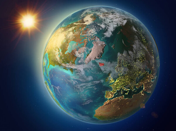 Sunset above Iceland highlighted in red on planet Earth with atmosphere and clouds. 3D illustration. Elements of this image furnished by NASA.