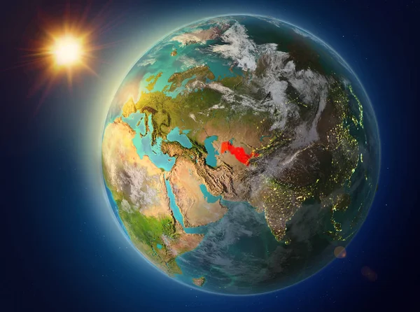 Sunset above Uzbekistan highlighted in red on planet Earth with atmosphere and clouds. 3D illustration. Elements of this image furnished by NASA.