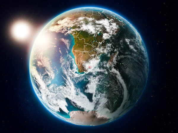 Sunset above Lesotho highlighted in red on planet Earth with clouds and visible country borders. 3D illustration. Elements of this image furnished by NASA.