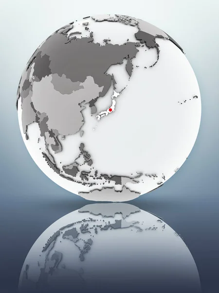 Japan with flag on globe reflecting on surface. 3D illustration.