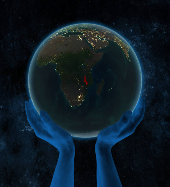 Malawi on night Earth in hands in space. 3D illustration.