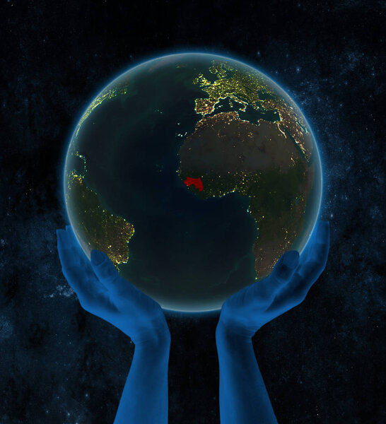 Guinea on night Earth in hands in space. 3D illustration.