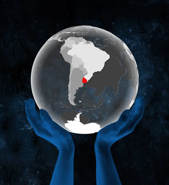 Uruguay on translucent globe in hands in space. 3D illustration.