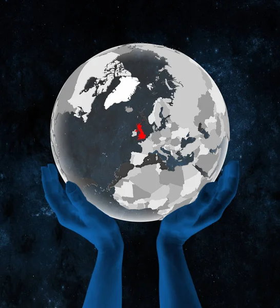 United Kingdom on translucent globe in hands in space. 3D illustration.