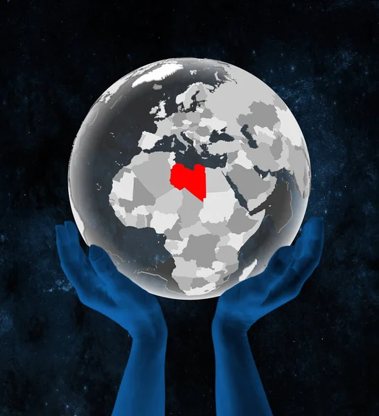 Libya on translucent globe in hands in space. 3D illustration.