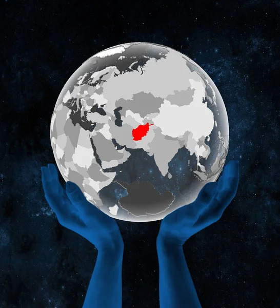 Afghanistan on translucent globe in hands in space. 3D illustration.