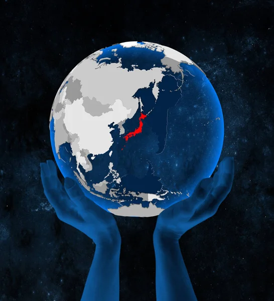 Japan on translucent blue globe held in hands in space. 3D illustration.