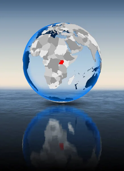 Uganda In red on globe floating in water. 3D illustration.
