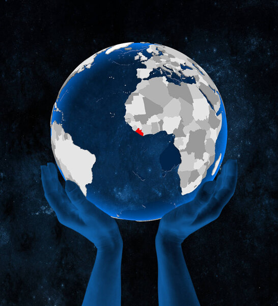 Liberia on translucent blue globe held in hands in space. 3D illustration.