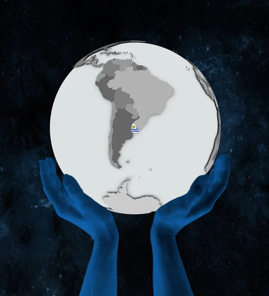 Uruguay with flag on globe in hands in space. 3D illustration.