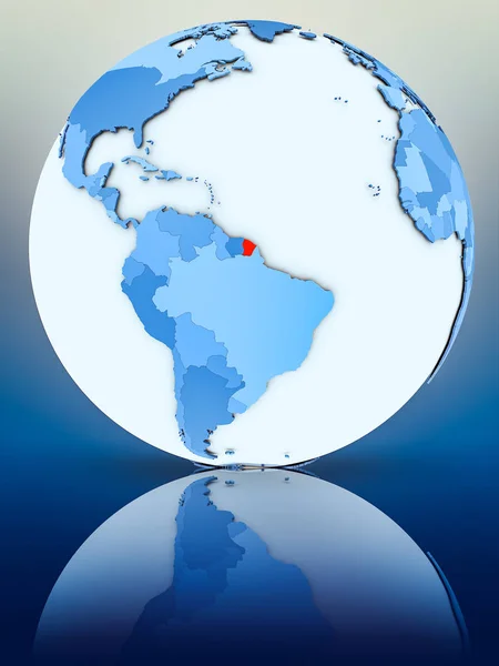 French Guiana on blue globe on reflective surface. 3D illustration.