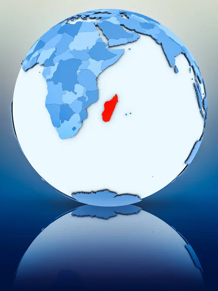Madagascar on blue globe on reflective surface. 3D illustration.