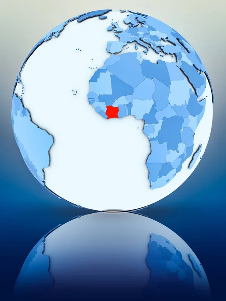 Ivory Coast on blue globe on reflective surface. 3D illustration.