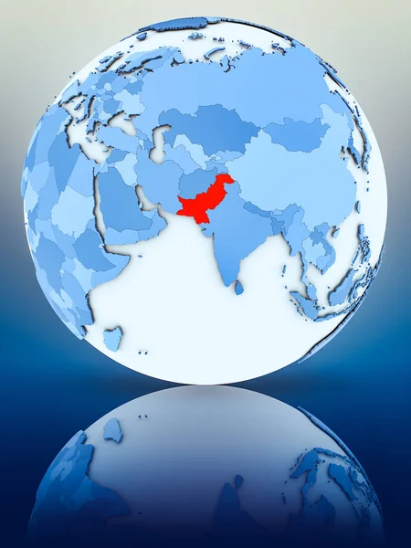 Pakistan on blue globe on reflective surface. 3D illustration.