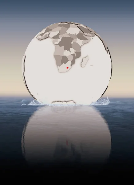 Lesotho In red on globe floating in water. 3D illustration.