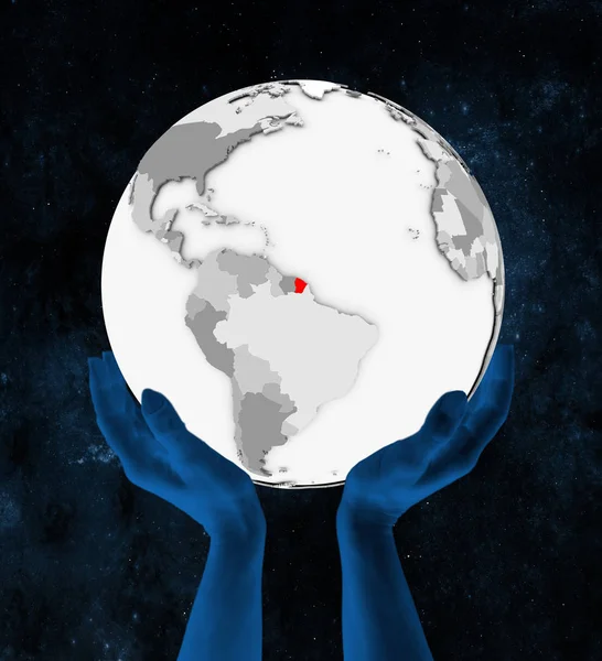 法国圭亚那以红色在白色地球手在空间举行 — 图库照片