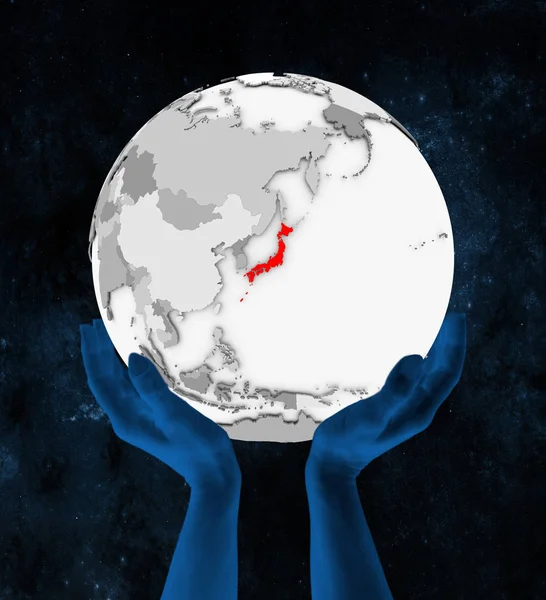Japan In red on white globe held in hands in space. 3D illustration.