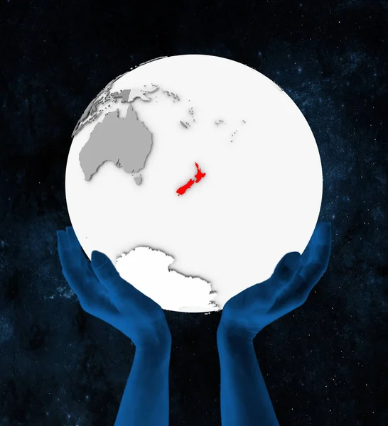 Uzayda Elinde Yeni Zelanda Içinde Kırmızı Beyaz Küre Üzerinde Tutulan — Stok fotoğraf