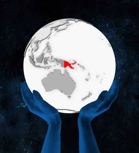 Papua Yeni Gine Içinde Kırmızı Beyaz Küre Üzerinde Eller Uzayda — Stok fotoğraf