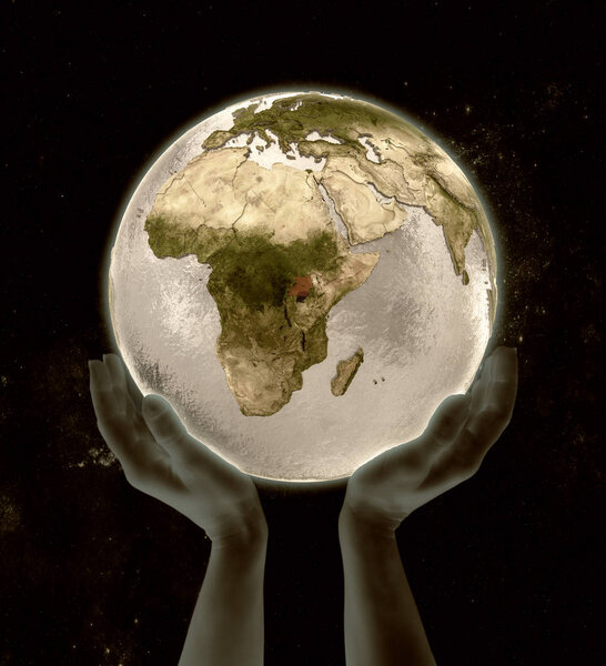 Uganda on globe in hands in space. 3D illustration.
