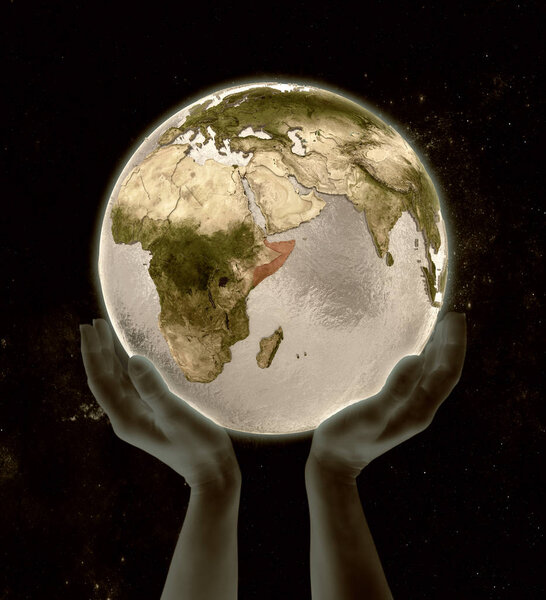 Somalia on globe in hands in space. 3D illustration.