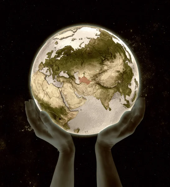 Turkmenistan on globe in hands in space. 3D illustration.