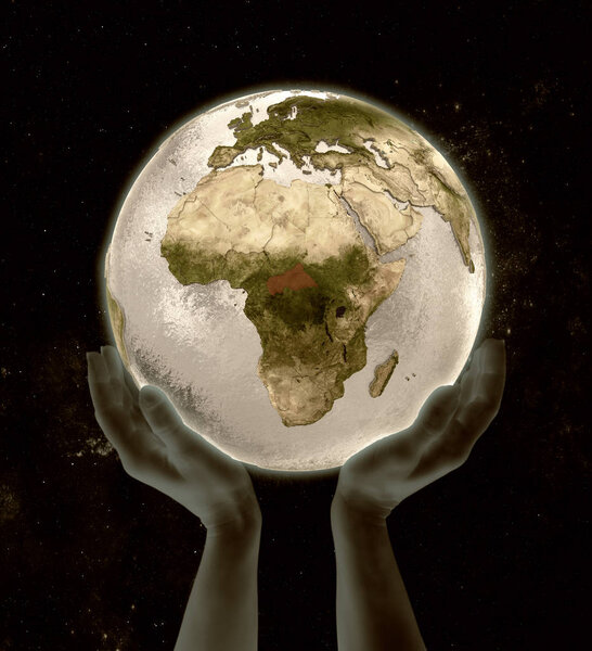 Central Africa on globe in hands in space. 3D illustration.
