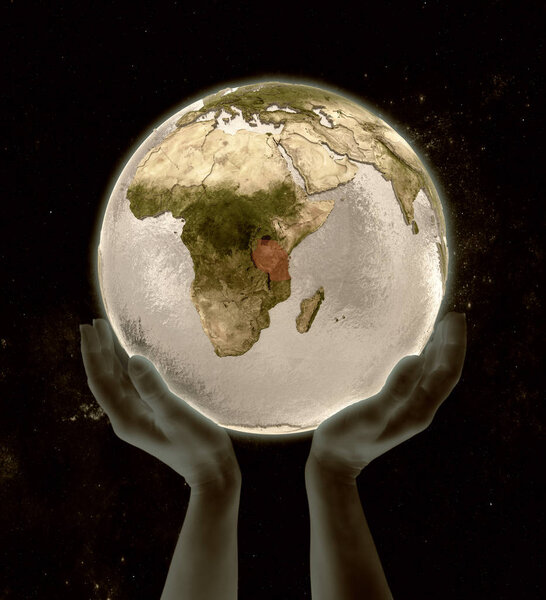 Tanzania on globe in hands in space. 3D illustration.
