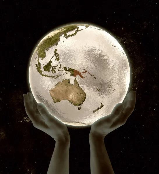 Papua New Guinea on globe in hands in space. 3D illustration.