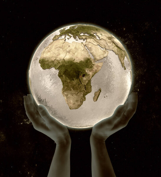 Rwanda on globe in hands in space. 3D illustration.