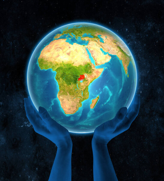 Uganda in red on globe held in hands in space. 3D illustration.