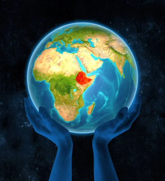 Ethiopia in red on globe held in hands in space. 3D illustration.
