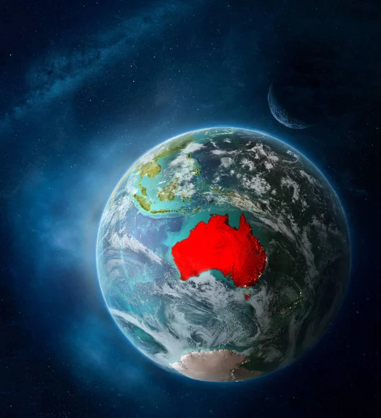 Australia from space on Earth surrounded by space with Moon and Milky Way. Detailed planet surface with city lights and clouds. 3D illustration. Elements of this image furnished by NASA.