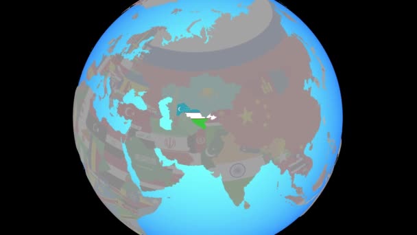 Zoom to Uzbekistan with flag on map — Stock Video