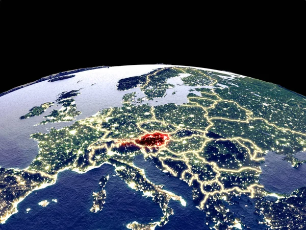 Austria from space on planet Earth at night with bright city lights. Detailed plastic planet surface with real mountains. 3D illustration. Elements of this image furnished by NASA.