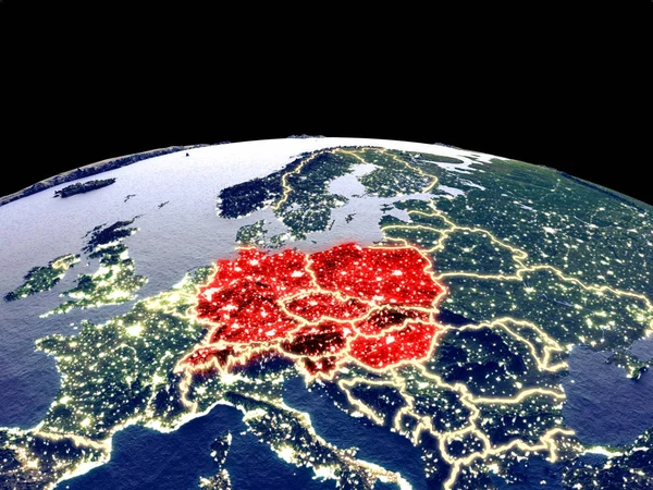 Central Europe from space on planet Earth at night with bright city lights. Detailed plastic planet surface with real mountains. 3D illustration. Elements of this image furnished by NASA.