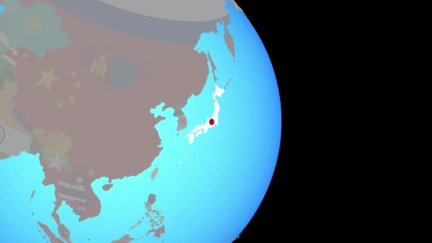 Zoom do Japonii z flagą na kuli ziemskiej — Wideo stockowe