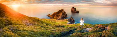 Scenic panorama of Cape Brett lighthouse on the coast of New Zealand during sunset. Located in Bay of Islands, popular tourist destination for its natural beauty. clipart