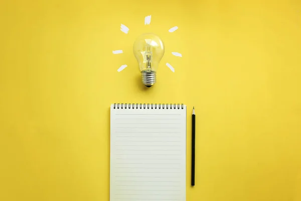 Flat Lay Light Bulb Empty Memo Pad Pencil Yellow Background — Stock Photo, Image