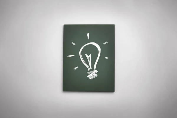 Black board with drawing of light bulb.