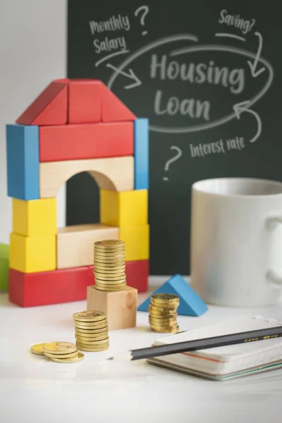 Home loan financial planning gold coin stacks on table top still life.