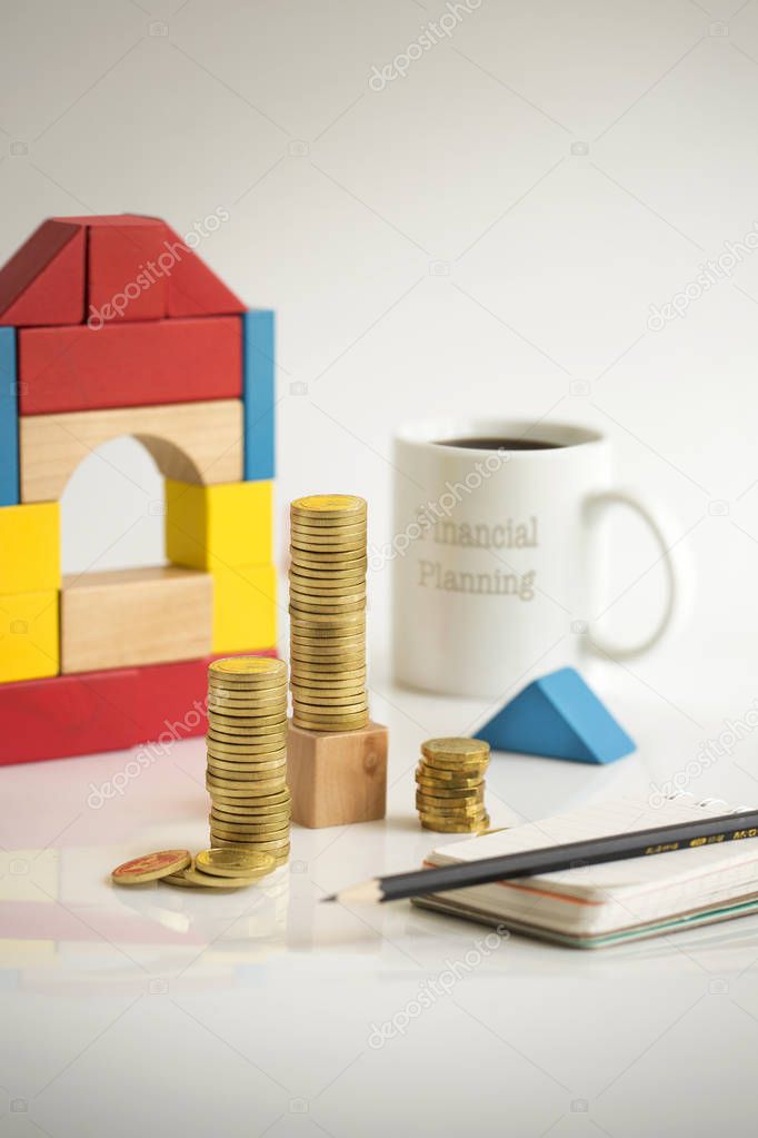 Home loan financial planning gold coin stacks on table top still life.