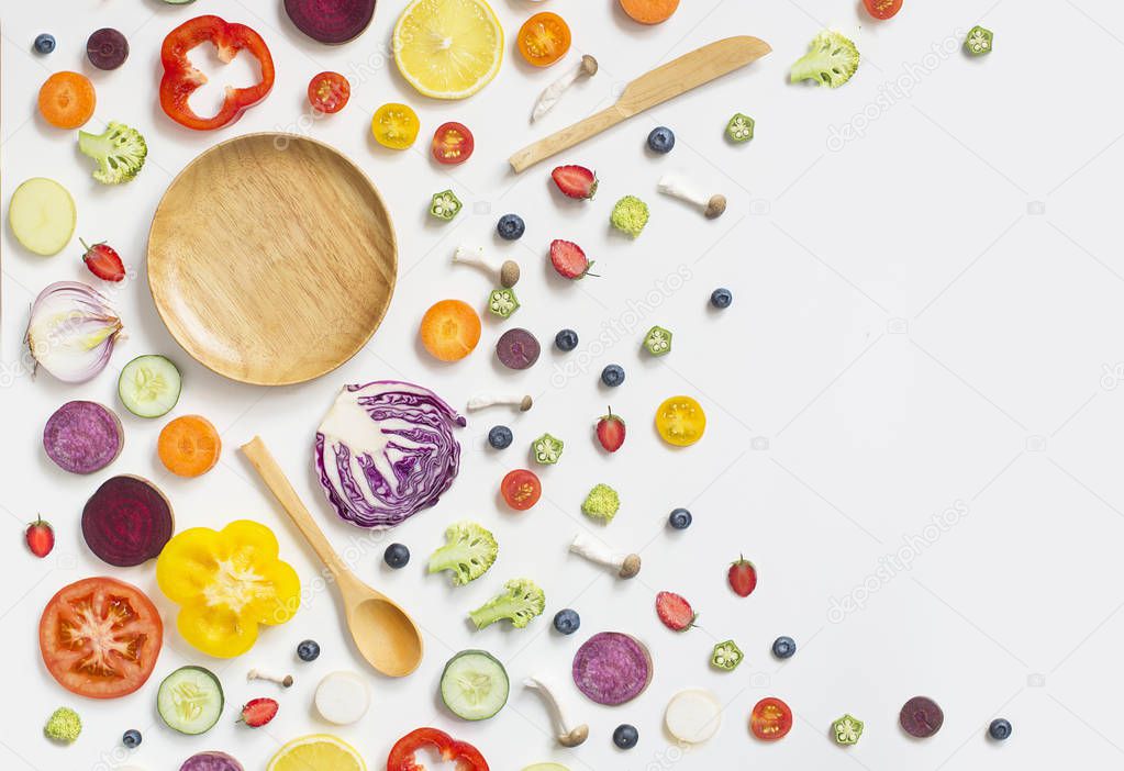 Colourful assorted raw vegan food sliced on white background.