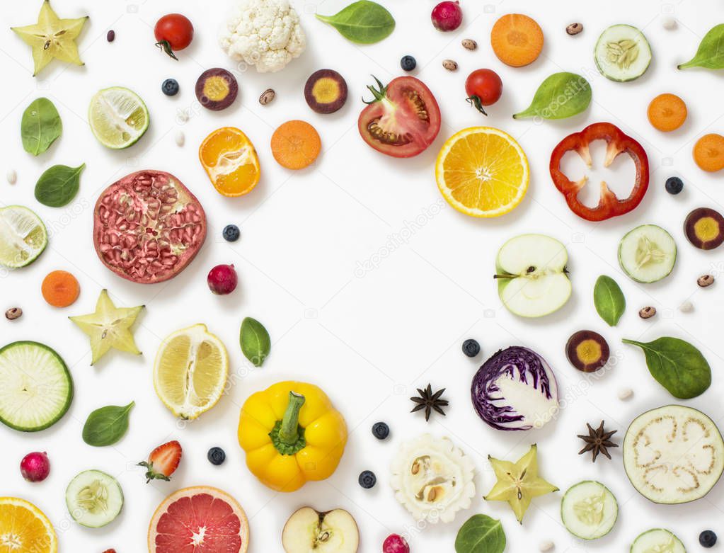 Various colourful sliced vegetables and fruits text space image.