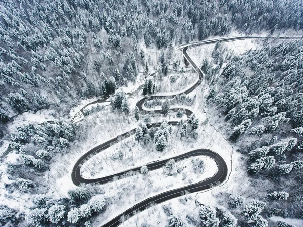 Extreme weather winding road in the winter covered with snow
